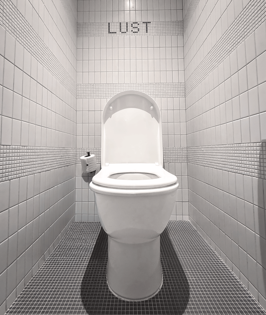 Shot of bathroom tiles in the bathroom tiles that reveal the word 'Lust'